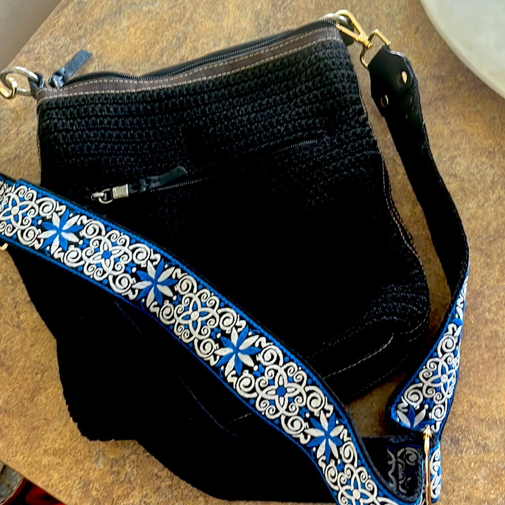Black woven SAK Crossbody with aftermarket guitar strap.